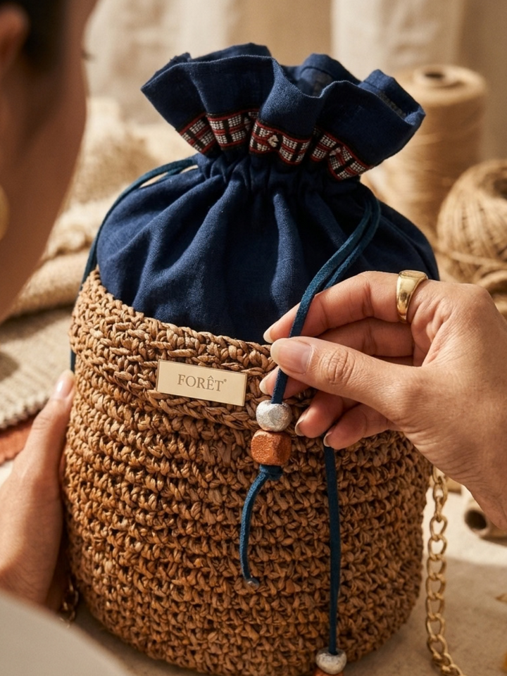 Artisan detail of handcrafted eco-friendly banana bark bag with tamarind seed accents